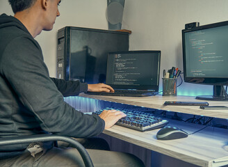 Programador escribiendo un código informático en su oficina por la noche