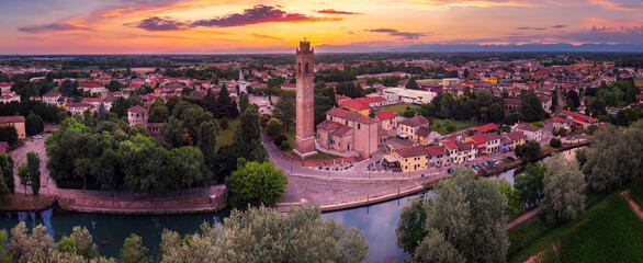 Aerial view of the Casale sul Sile church and harbour on the river Sile at Sunset. On the left the medieval Carraresi Tower.