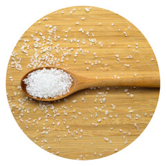 Table rock salt used in dishes in a wooden spoon on a bamboo background