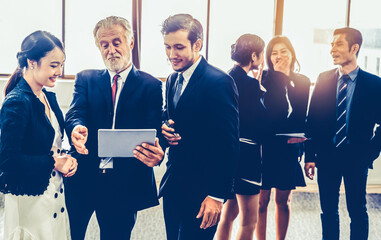Many young businessmen and businesswomen in group meeting standing at conference hall in the...