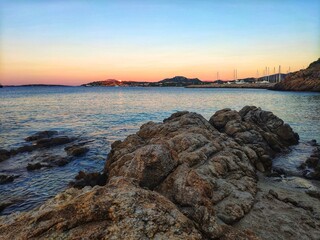 Blue hour in Portisco. Rocky shore. Blue hour. Sunset over rocks in Sardinia
