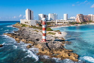 Aerial view of Punta Cancun Lighthouse. The Lighthouse adorned with white and red stripes and...