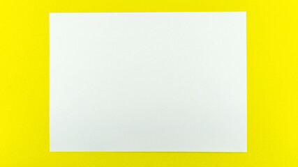 White sheet paper on yellow paper background copy space for your text advertising