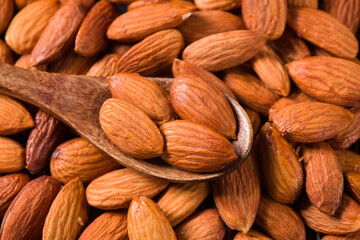 Fototapeta premium Delicious roasted sweet almonds nuts background
