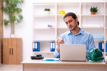 Young male architect working in the office