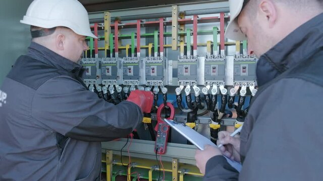 Checking the operating voltage levels of the solar panel switchgear compartment