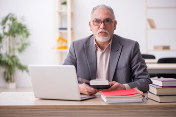 Aged male teacher in the classroom