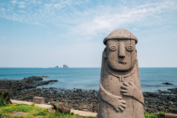 Dol hareubang stone grandpa sculpture and sea, Jeju Olle Trail in Jeju Island, Korea