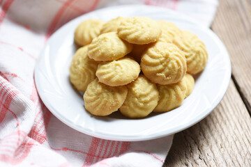 cookies vanilla on white plate and wooden background, mini cookies biscuits