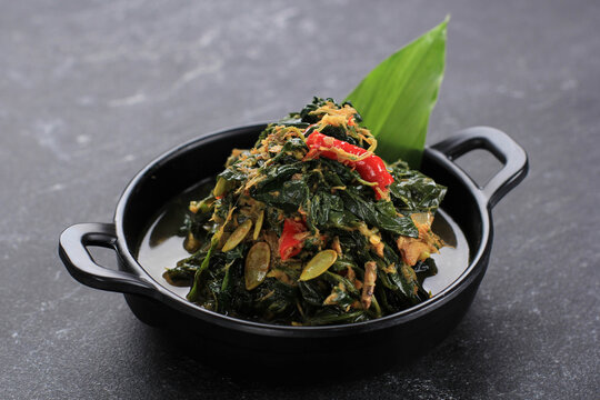 Stir Fry Papaya Leaves or Tumis Daun Pepaya (Singkong Tumbuk) Made from Boiled Papaya or Cassava Leaves with Spice and Chilli. Usually add Fried Anchovies. Sometimes Called Buntil