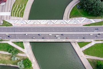 cars traffic on bridge over the river. modern urban architecture. aerial top view.