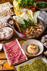 Shabu shabu on the table ready to eat, black soup