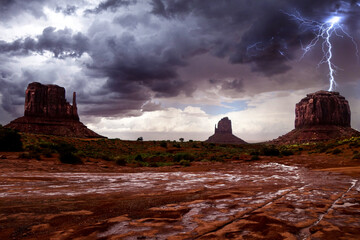 Lighting strikes a large butte during a heavy thunderstorm in Monument Valley, Arizona.
