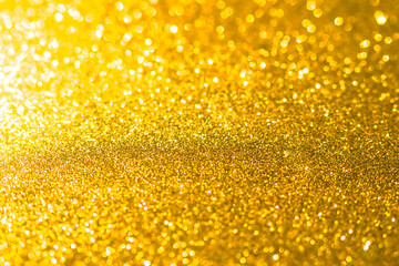Golden bokeh background happy new year 2022. yellow abstract glister effect light night out of focus circle wallpaper. for christmas party celebration holidays or technology background concept.