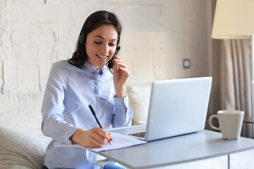 Freelance operator talking with headsets and consulting clients from home office.