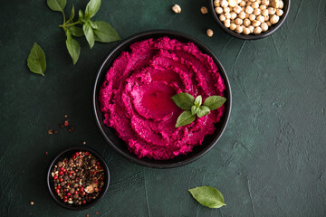 Humus Bowl. Red beetroot hummus with fresh vegetables, olive oil on table
