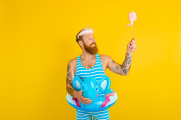 Happy man with life buoy ,princess crown and magic wand acts like a fairy