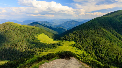 Fototapeta na wymiar Green mountain ridge in nice weather, with blue sky and white clouds. Mala Fatra, Slovakia.