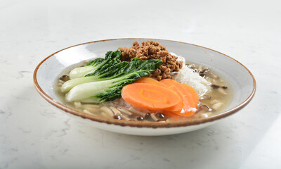 boiled cook bee hoon vermicelli noodle with mushroom, vegetable, carrot and minced meat in soup asian quorn halal menu