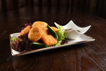 deep fried golden crispy chicken or fish nugget with homemade sauce on wood table snack Halal menu