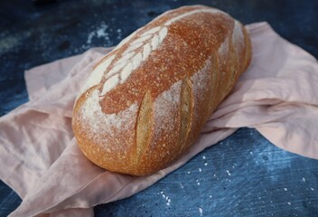 Loaf of Sour Dough Bread on Linen and Background