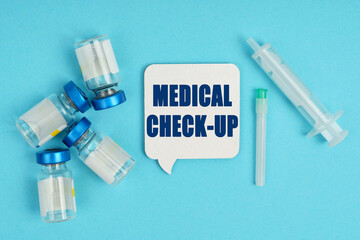 On the table is a syringe, an injection and a white plaque - thoughts with the inscription -...