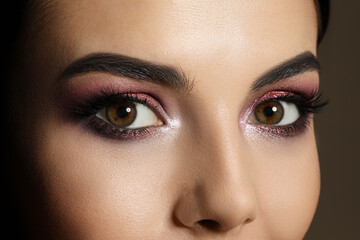 Young woman with evening makeup, closeup. Eye shadow product