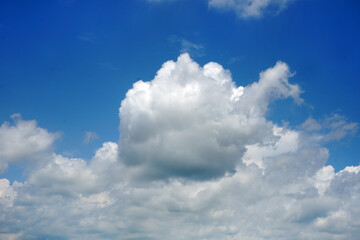 Naklejka na ściany i meble White cumulus clouds on blue sky background.