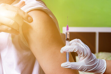 Doctor or nurse is injecting COVID-19 vaccine to patient,Vaccination and prevention against flu and...