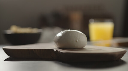 mozzarella ball on olive wood board