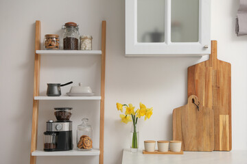 Obraz na płótnie Canvas Modern coffee grinder on shelving unit in kitchen