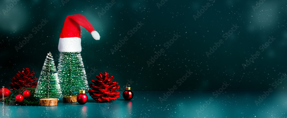 Aufkleber merry christmas and happy new year snow falling with xmas tree and red santa clause hat on dark gree