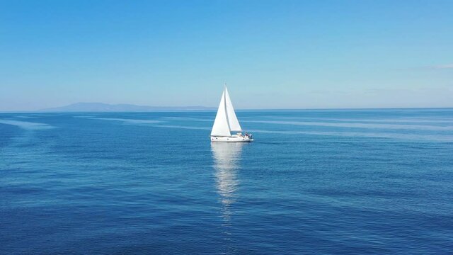 Aerial view of sailing luxury yacht at opened sea at sunny day in Croatia, view from drone