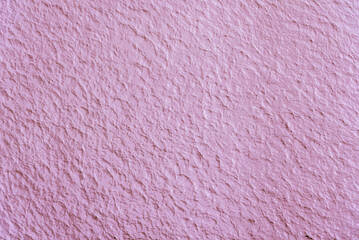 Pink textured background. Concrete plastered textured surface painted pink.