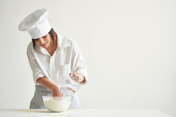 woman chef kneading dough working with flour Professional