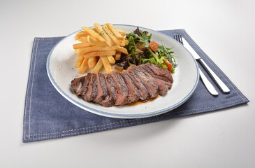 bbq grilled juicy wagyu beef tenderloin sirloin steak in brown black pepper sauce with French fries and vegetables salad dressing western cuisine menu