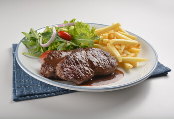 bbq grilled juicy wagyu beef tenderloin sirloin steak in brown black pepper sauce with French fries and vegetables salad dressing western cuisine menu