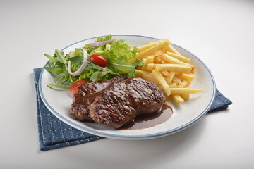bbq grilled juicy wagyu beef tenderloin sirloin steak in brown black pepper sauce with French fries and vegetables salad dressing western cuisine menu