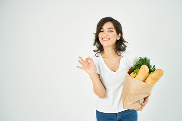 woman with a package of groceries vegetables healthy eating positive hand gesture