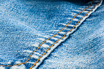 clothing items blue stonewashed faded jeans cotton fabric texture with seams, clasps, buttons and...