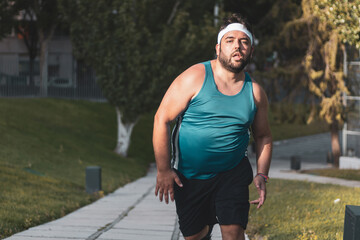 a fat boy running in an outdoor park.
willpower.
determination.