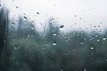 Natural summer background - raindrops on the window glass, close up.