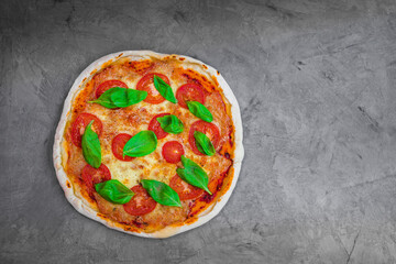 freshly baked Italian pizza with cheese and tomato sauce, garnished with basil leaves. Ingredients. view from above 