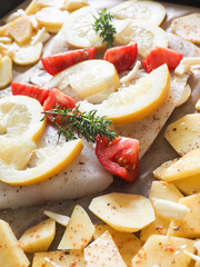 Cod fillet garnished with thyme garlic and tomatoes, preparation of a healthy dish