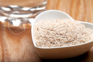 Portion of Psyllium Seeds on rustic wooden background. Natural light. Selective focus.