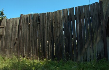 Old wooden fence in a rustic courtyard.