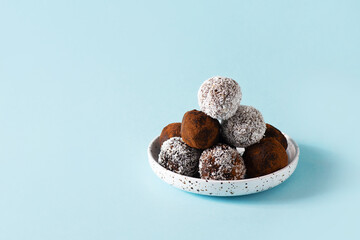 Carob energy balls with nuts, dates and coconut, vegan and vegetarian sweet food