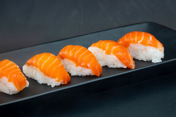Salmon Nigiri on  black plate