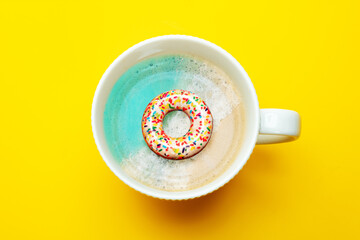 Beach in the coffee mug with inflatable doughnut