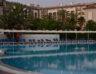 Pool with calm blue water in the evening twilight